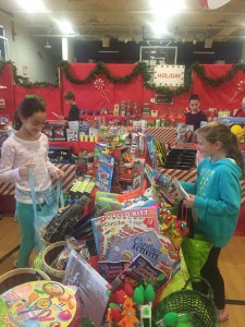 A couple of my classmates getting gifts at the Candy Cane Cottage.